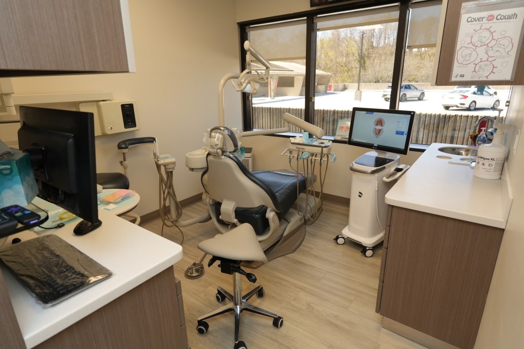Dental treatment room with advanced dental equipment and patient chair.