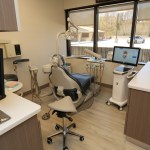 Dental treatment room with advanced dental equipment and patient chair.