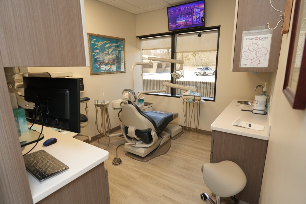 Private dental operatory with modern technology and treatment station.