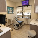 Private dental operatory with modern technology and treatment station.