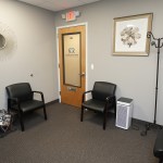 Comfortable dental office waiting area with chairs and reception decor.